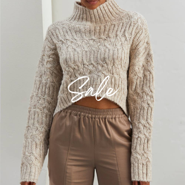 A woman wearing a mock neck sweater