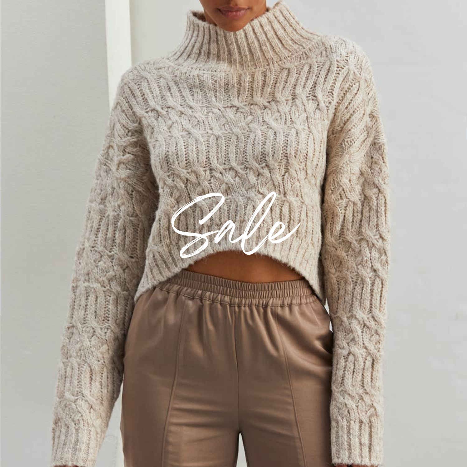 A woman wearing a short sleeve, knee-length brown chiffon dress with a round neckline and ruffle detailing.