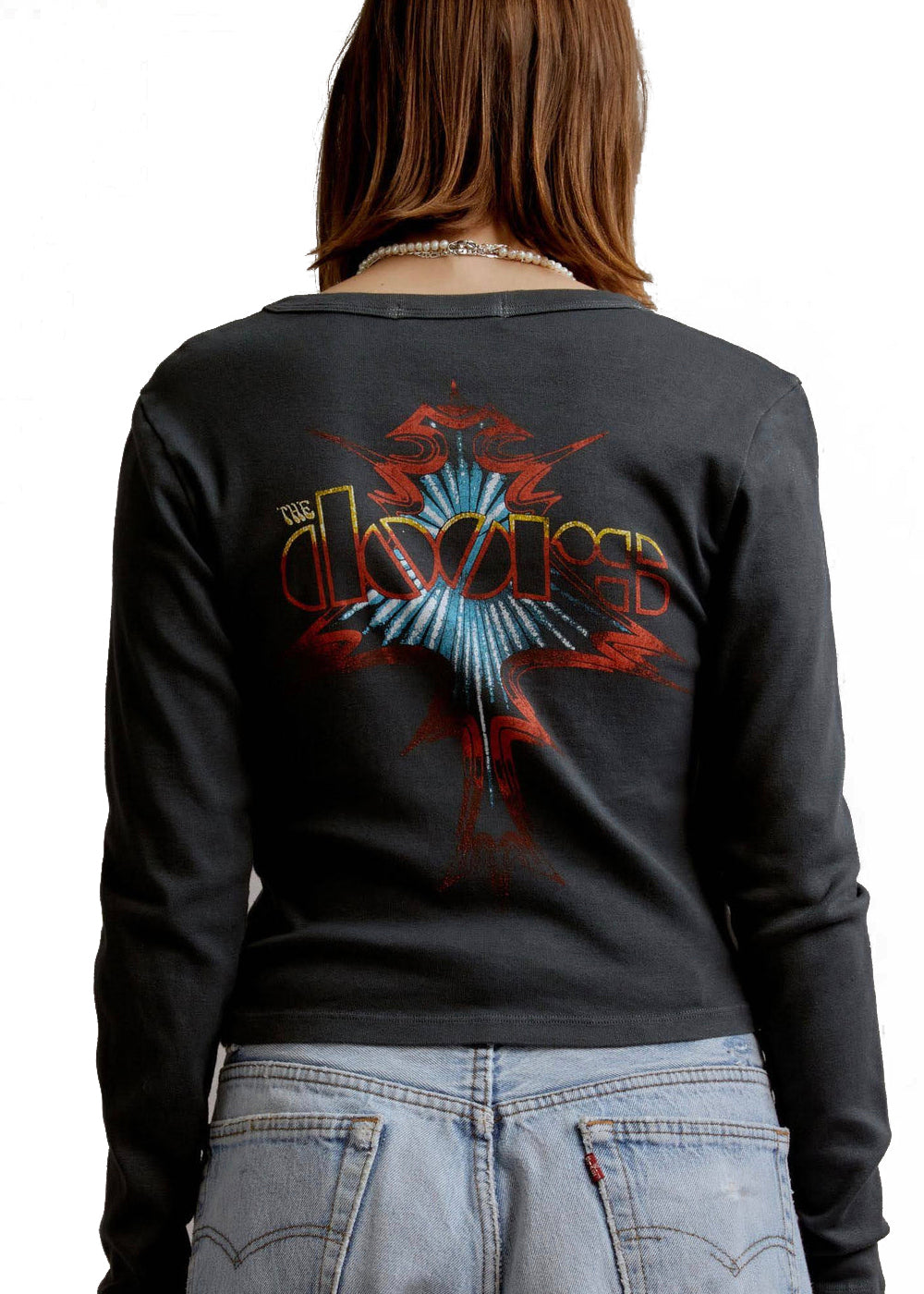 Black long-sleeve shirt with a colorful graphic on the back, worn by a person.