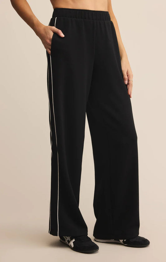 Black track pants with two white stripe piping down the side