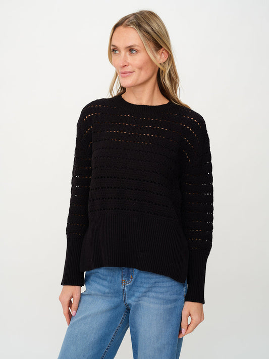 Woman wearing black Jaden crochet sweater and jeans